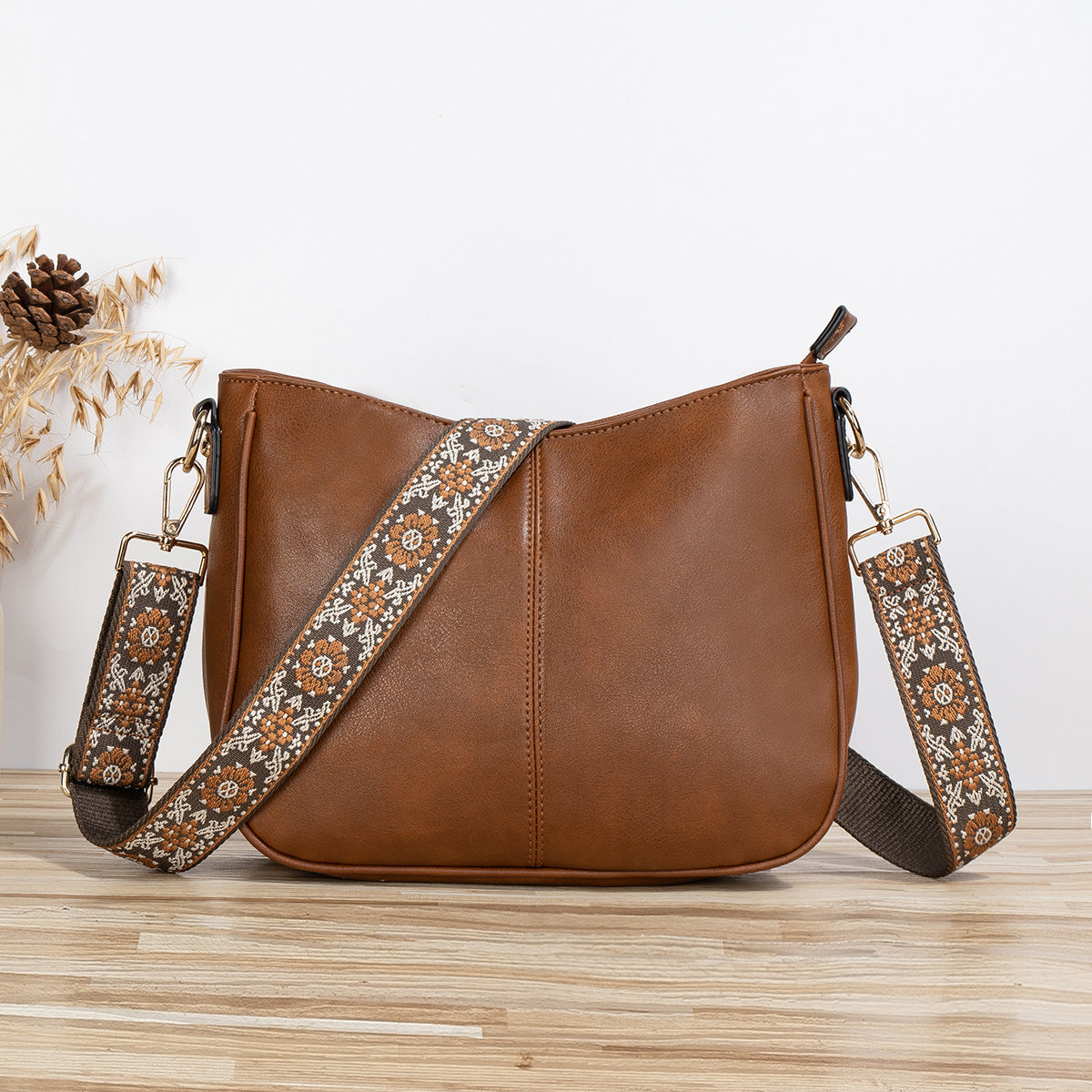 Shoulder bag with patterned strap in brown