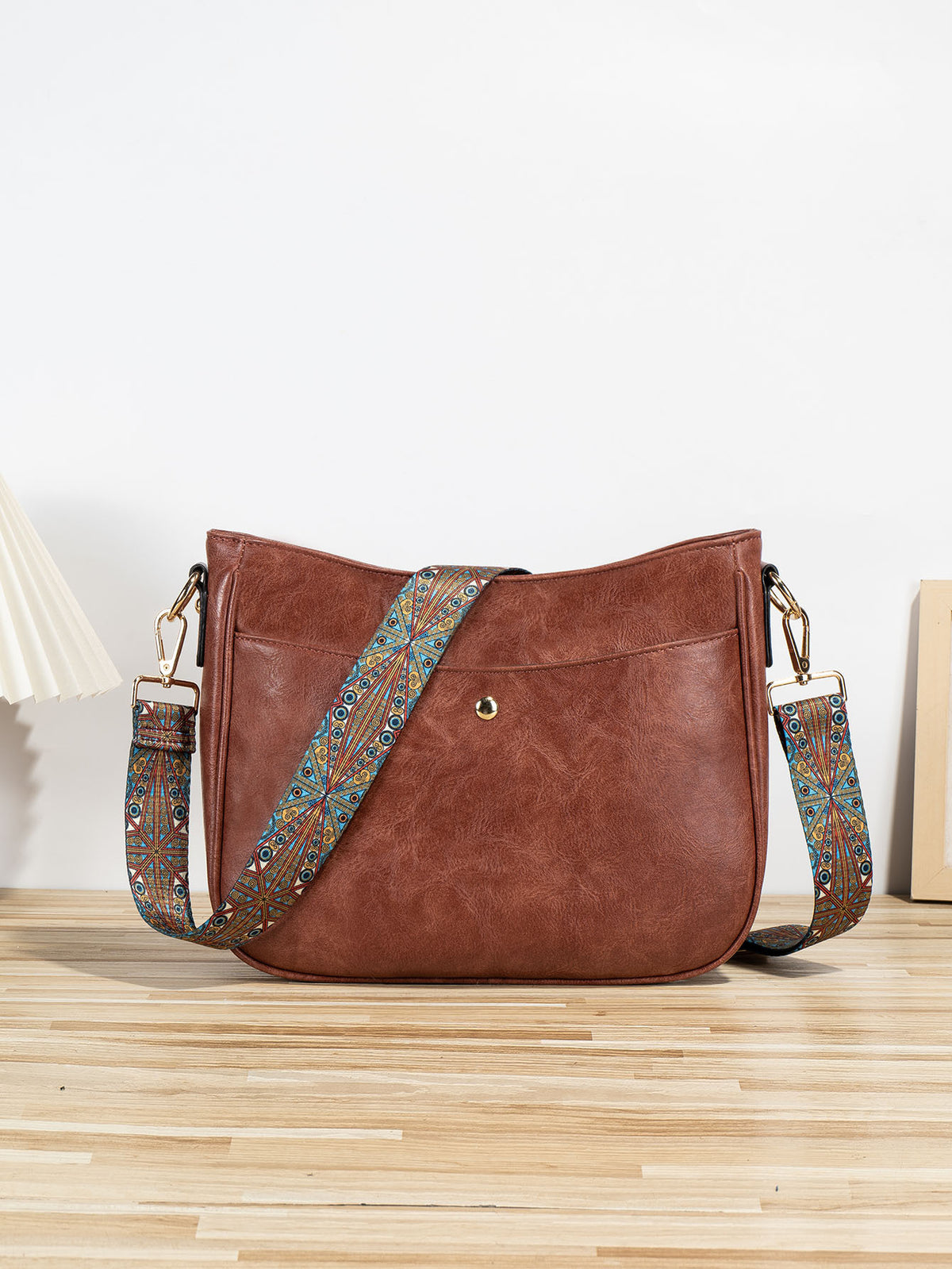 Shoulder bag with patterned strap in wine red