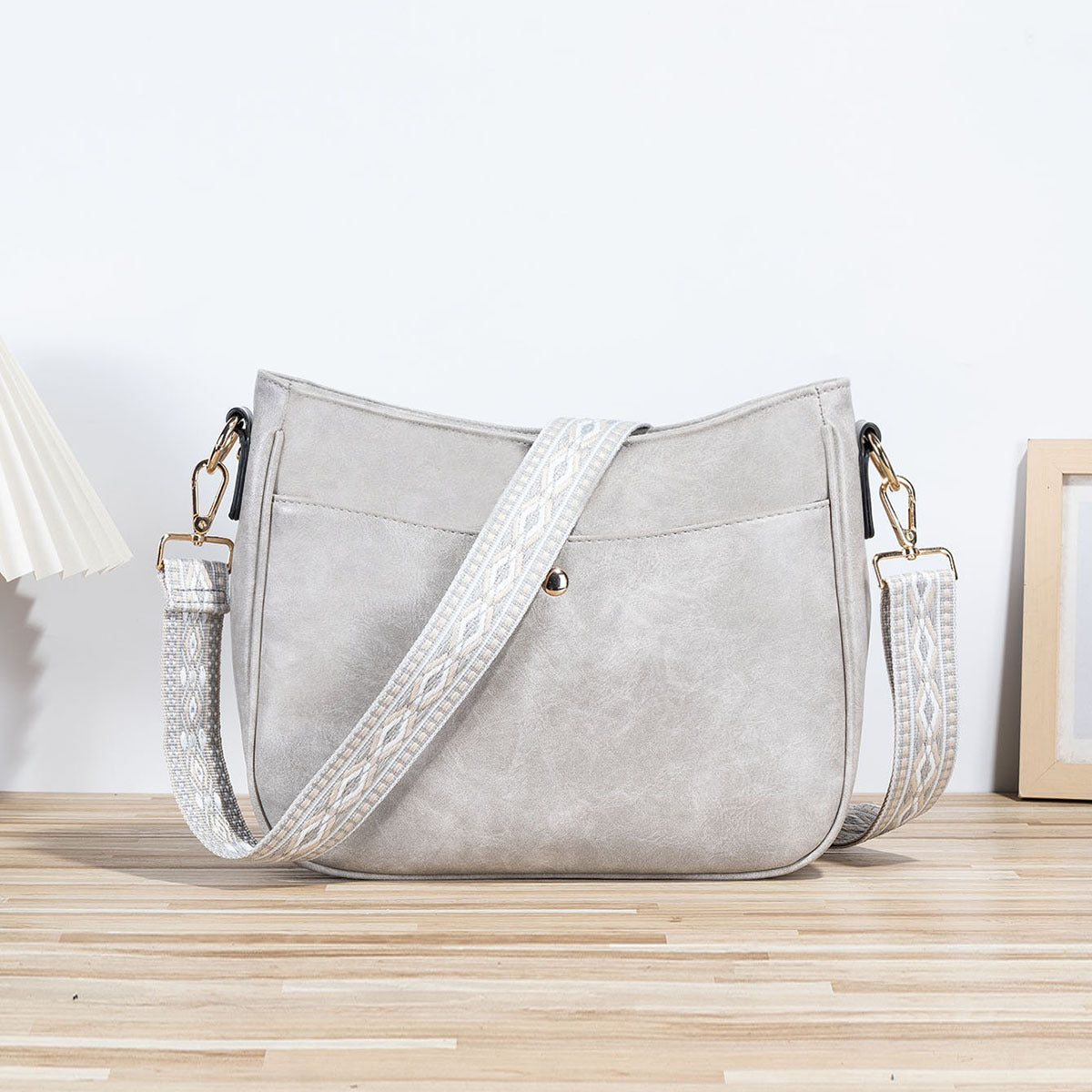 Shoulder bag with patterned strap in gray