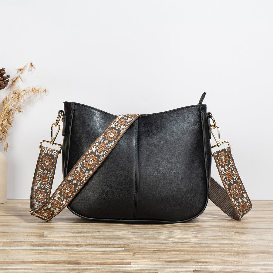 Shoulder bag with patterned strap in black